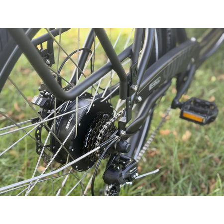 Close-up of the EMU E-Haul's Bafang rear hub motor, Shimano cassette and rear disc brake, with grass behind